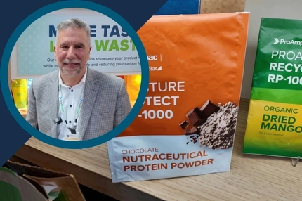 Image ProAmpac video thumbnail: Man standing beside sustainable product packaging displays, including chocolate nutraceutical protein powder and dried mang