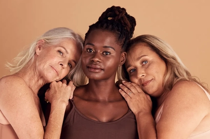 Image Three older woman together hugging.