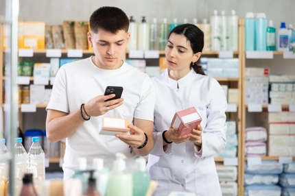 Man and woman scanning supplements in store