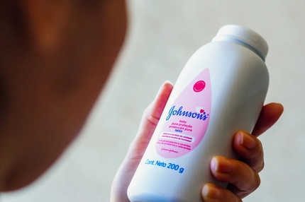 Image Woman looking at a baby powder bottle