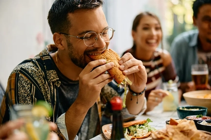 Image Man biting into burger.