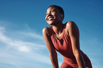 Image A woman smiling outside.