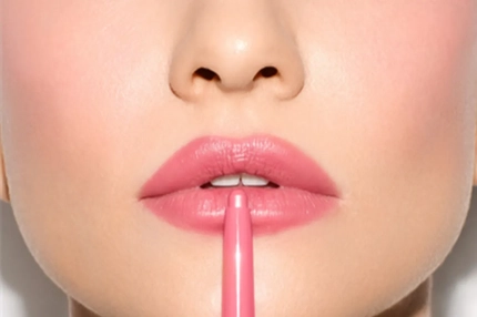 Image A woman putting on lip liner.