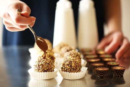 Image Putting chocolate on pralines.