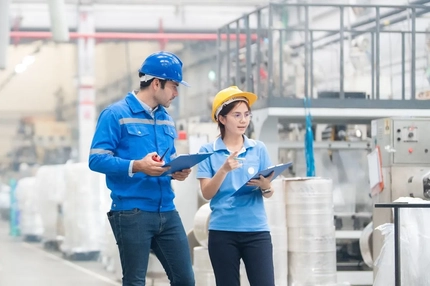 Image Two people walking in a plastic production factory
