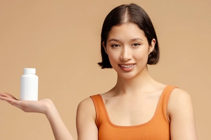 Image Woman taking beauty supplements