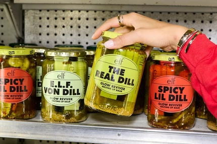 Image A hand reaching for ELF branded pickles.