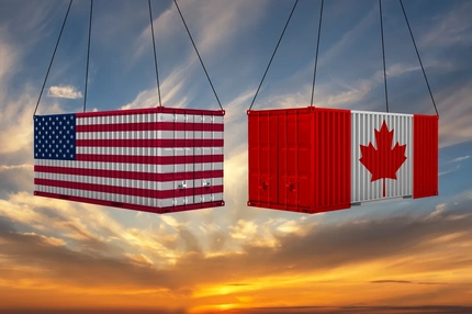 Two shipping containers with one having a US flag on it and the other a Canadian flag.