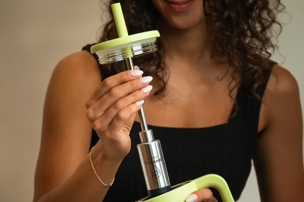 Image A woman holding a straw with a filter