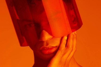 Image young man with futuristic orange plastic covering face