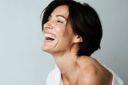 Image woman in 40s laughing