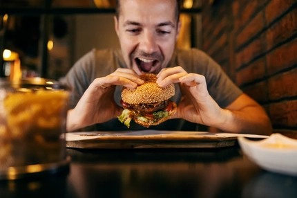 Image man eating burger