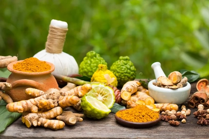 Image Turmeric powder, Turmeric in Mortar Grinder, other species and ingredients on wooden board
