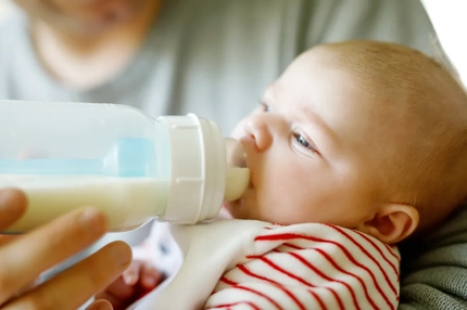 Image Baby drinking from bottle