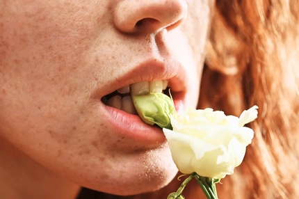 Image Woman with a flower in her mouth