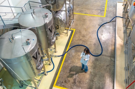 Image female scientist with fermentation tanks