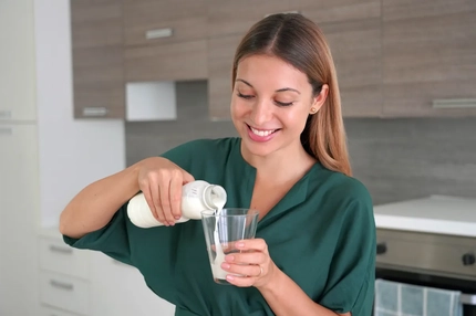 Image Woman pouring a probiotic drink
