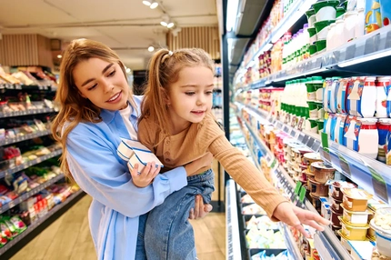 Image Woman and child in supermarket, looking at products.
