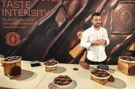 male chef in white apron with biscuit samples