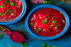 Image Beetroot soup served in blue bowls