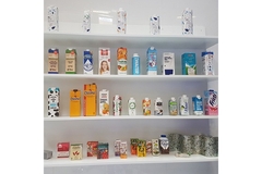 Image Shelves displaying various Tetra Pak beverage cartons in different sizes and designs.