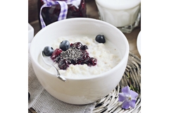 Image Bowl of oatmeal topped with blueberries, chia seeds, and berry compote.