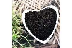 Image Trinutra's cold-pressed black seed in a heart shaped bowl.