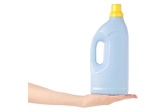 Hand holding a blue plastic detergent bottle with a yellow cap