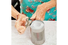 Image Old lady trying to open steel can