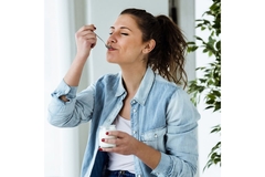 Woman eating yogurt.