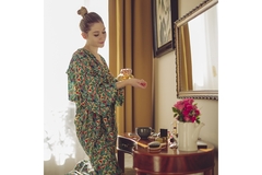 Image Woman applying perfume at vanity table in cozy bedroom morning routine