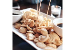 A plate of food with chopsticks and soy sauce