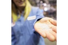 Image Hand holding plastic resin pellets