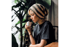 Woman drinking hot beverage indoors
