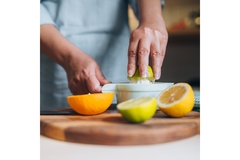 Image Squeezing limes and lemons with a squeezer