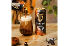 Image A cup of Guinness coffee beer, a dark and rich beverage with a creamy foam on top, served in a glass.