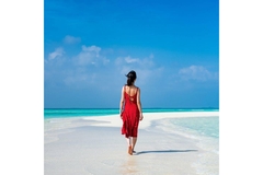 Image A lady walking at the beach wearing a nice red dress