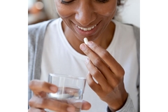 Image Woman taking vitamin