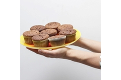 Image Two hands holding a plat of muffins