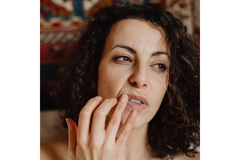 woman applying sun protection on her lips