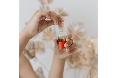 Image woman's hands pouring oil into a glass container