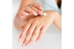 Image A person applies lotion to their hands.