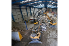 Image packaging waster being sorted through machines at a recycling facility