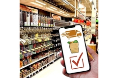 Holding phone with food scanner app in supermarket.