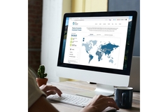 Woman looking at laptop with stocks on them.