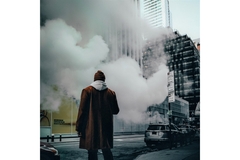 Image man in orange coats stands on pavement as smog from traffic rises up
