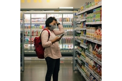 Image Person standing in supermarket aisle