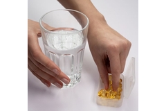 Image Person taking a capsule.