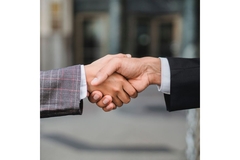 Image two people shaking hands on a business deal