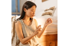 Image woman spraying perfume on wrist